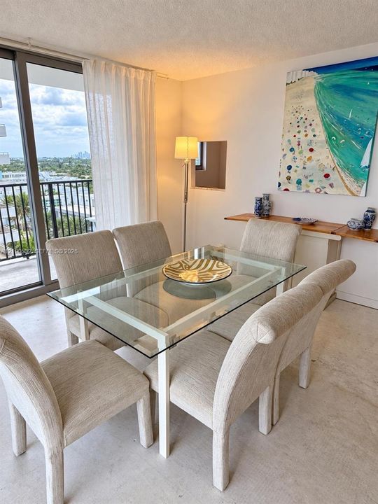 Full-height glass sliding doors, private exterior balcony with metal railing, and recessed wall niche