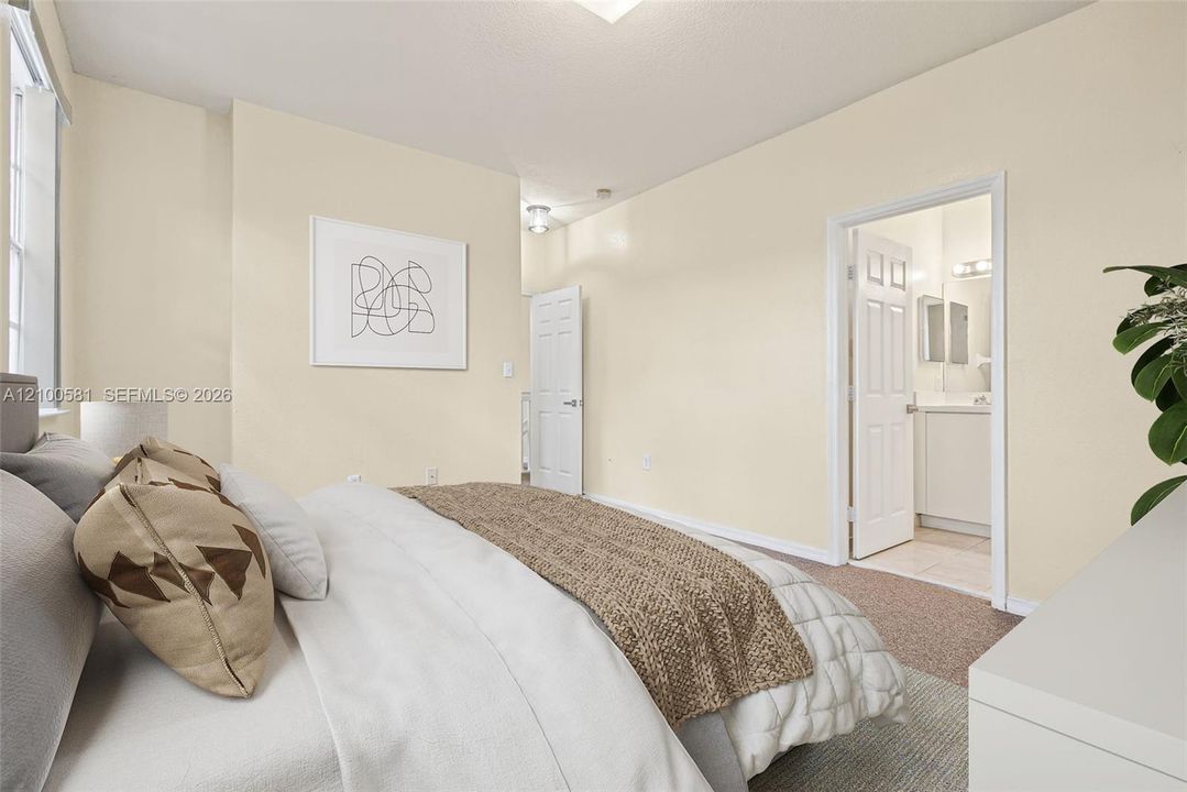 Neutral-toned bedroom featuring carpeted flooring, large window, and paneled interior doors