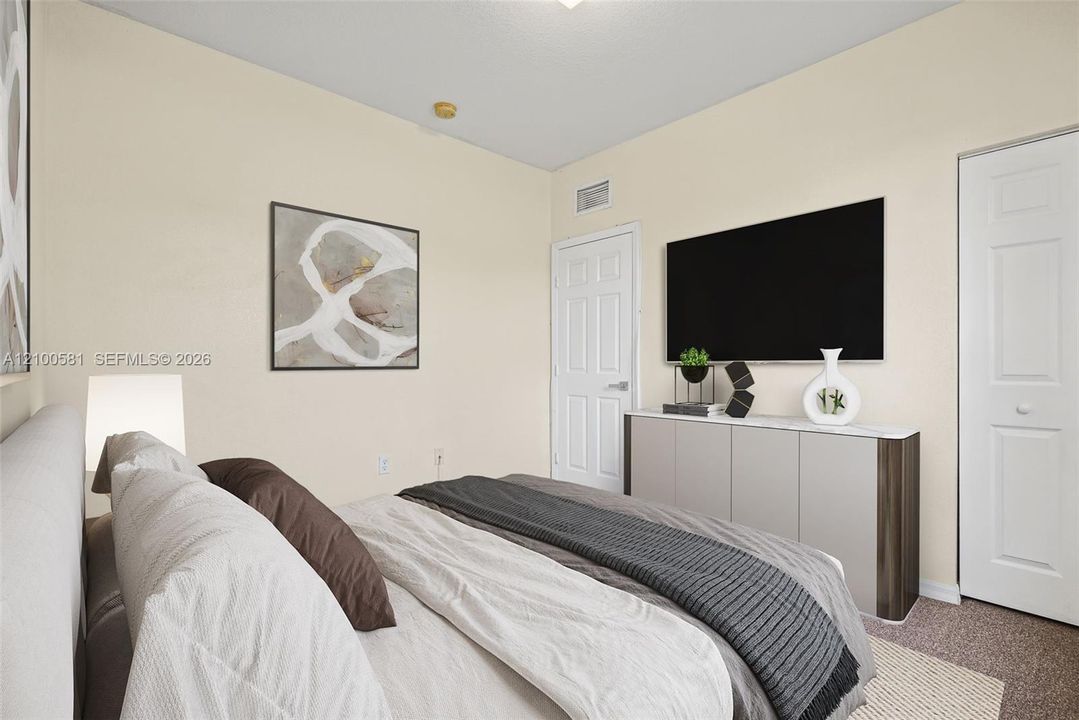 Neutral interior room featuring plush carpeting, a single-panel interior door, and a multi-panel closet door