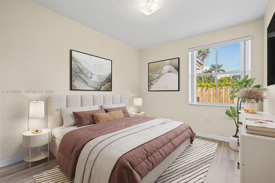 Neutral-toned interior featuring wood-finish flooring, a single-hung window with a screen, and a flush-mount ceiling light fixture