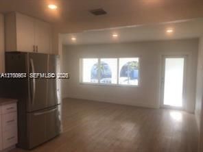 View from kitchen to social area, vinyl plank flooring throughout for easy maintenance, LED high hats.