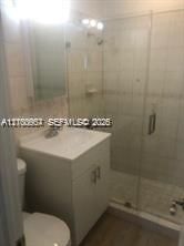 Bathroom with walk-in shower and glass enclosure.