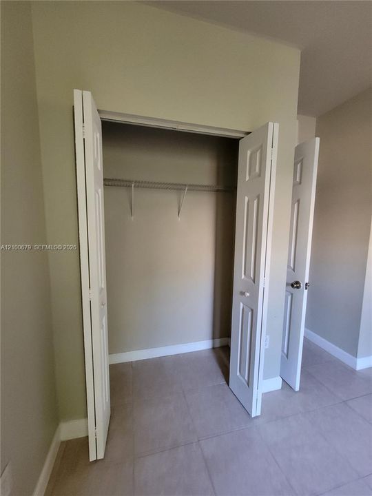 Closet featuring white six-panel bi-fold doors and interior wire shelving
