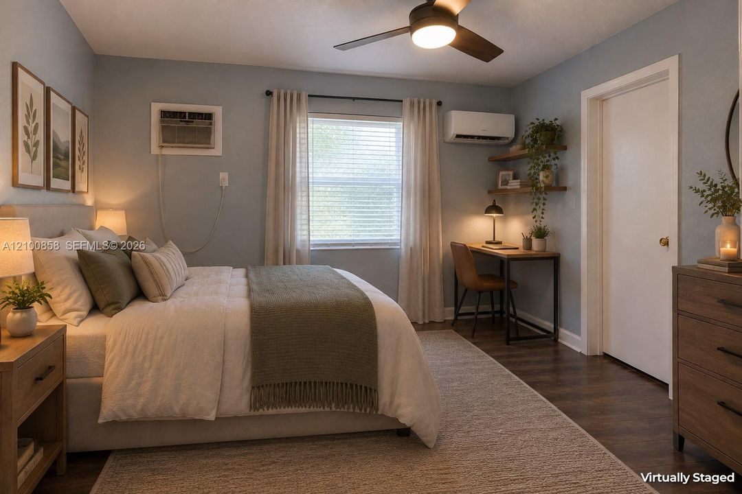 Bedroom featuring wood-finish flooring, a ceiling fan with integrated lighting, a wall-mounted ductless mini-split system, and built-in wall shelving