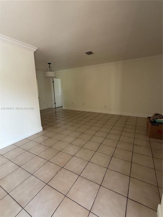 Covered patio featuring tiled flooring, built-in outdoor counter, and tile roof
