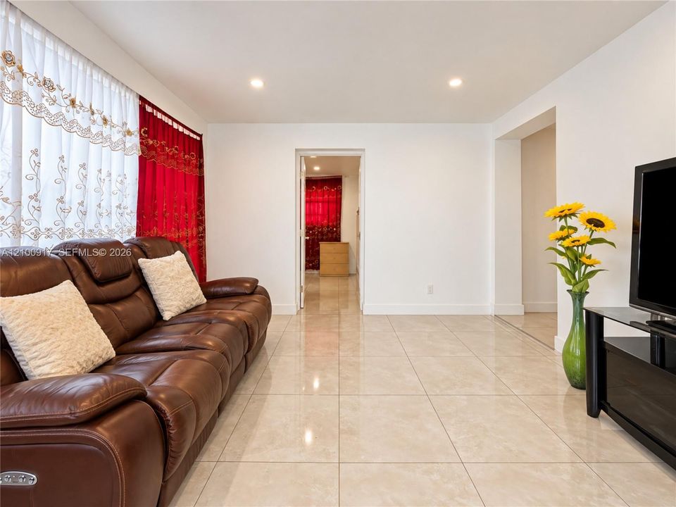 Recessed ceiling lighting illuminates the spacious interior featuring light-toned tile flooring