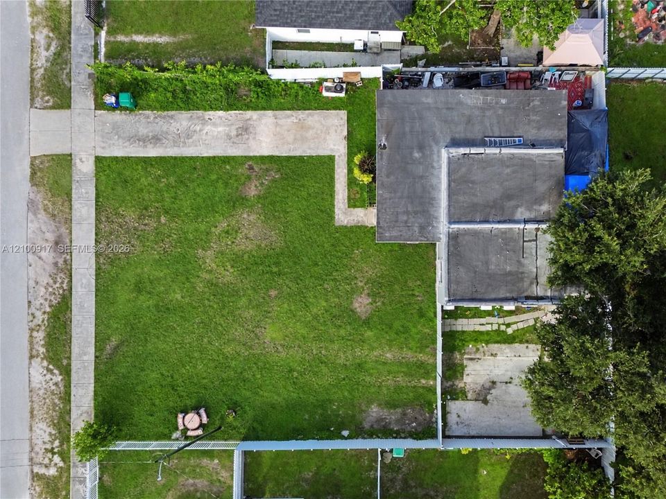 Expansive grassy yard with concrete pathways