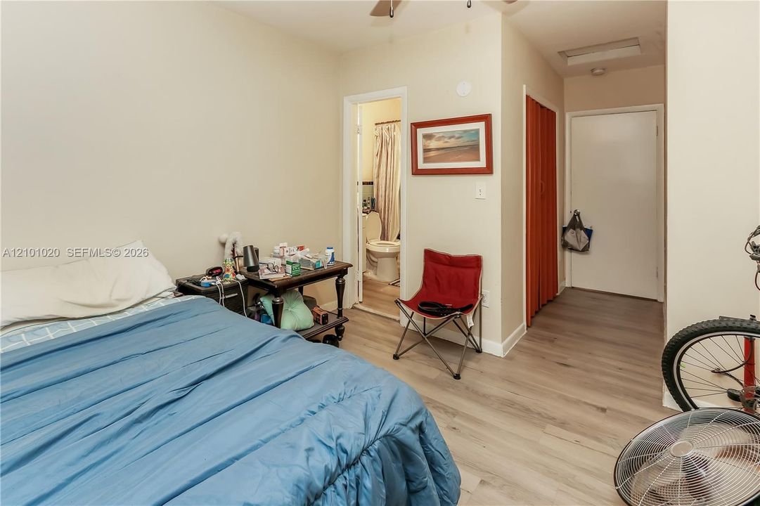 Wood-finish flooring, ceiling fan with integrated lighting, and bi-fold closet doors
