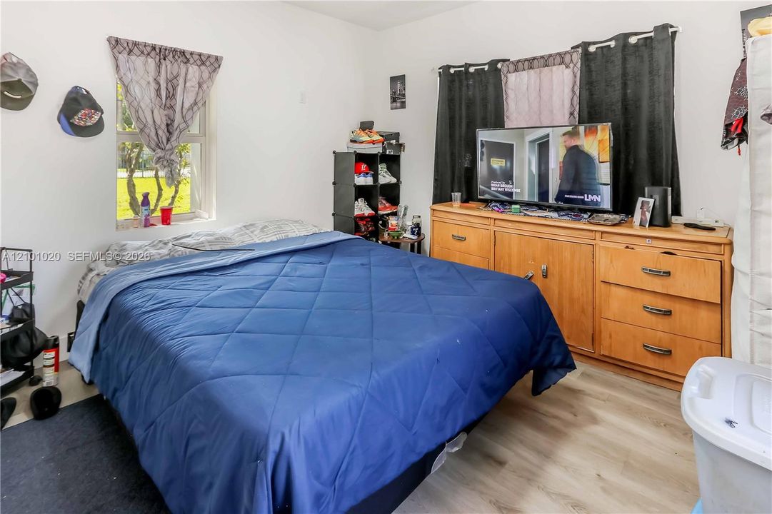 Room featuring wood-finish flooring and a single-hung window with natural light