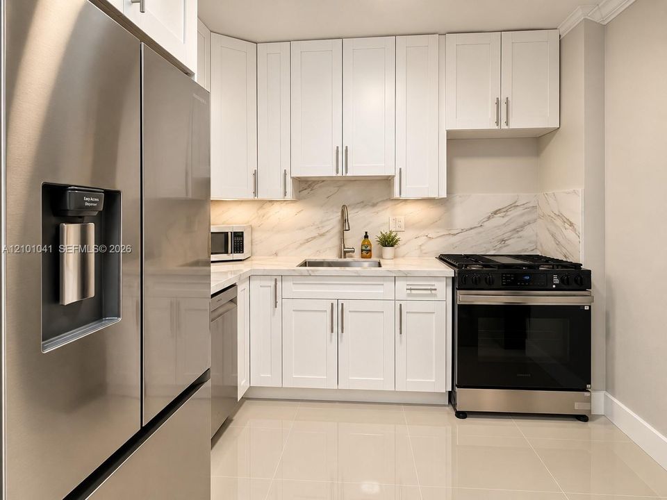 Kitchen featuring white shaker-style cabinetry, stone-patterned backsplash, stainless steel appliances, and tile flooring