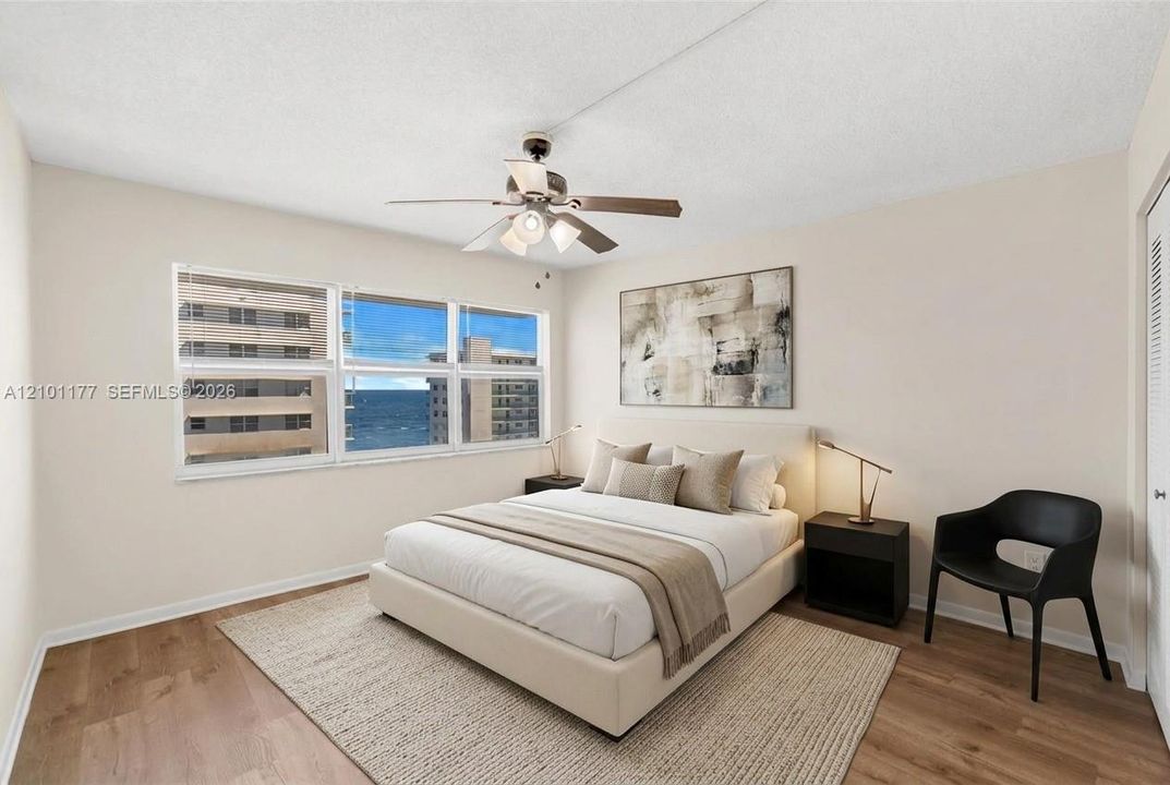 Multi-pane window, wood-finish flooring, and ceiling fan with integrated lighting