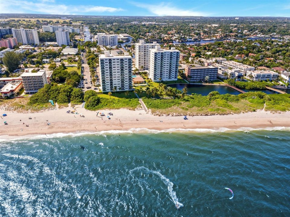 High-rise condominium buildings situated on a beachfront parcel featuring direct access to the ocean, coastal shoreline, and surrounding waterways