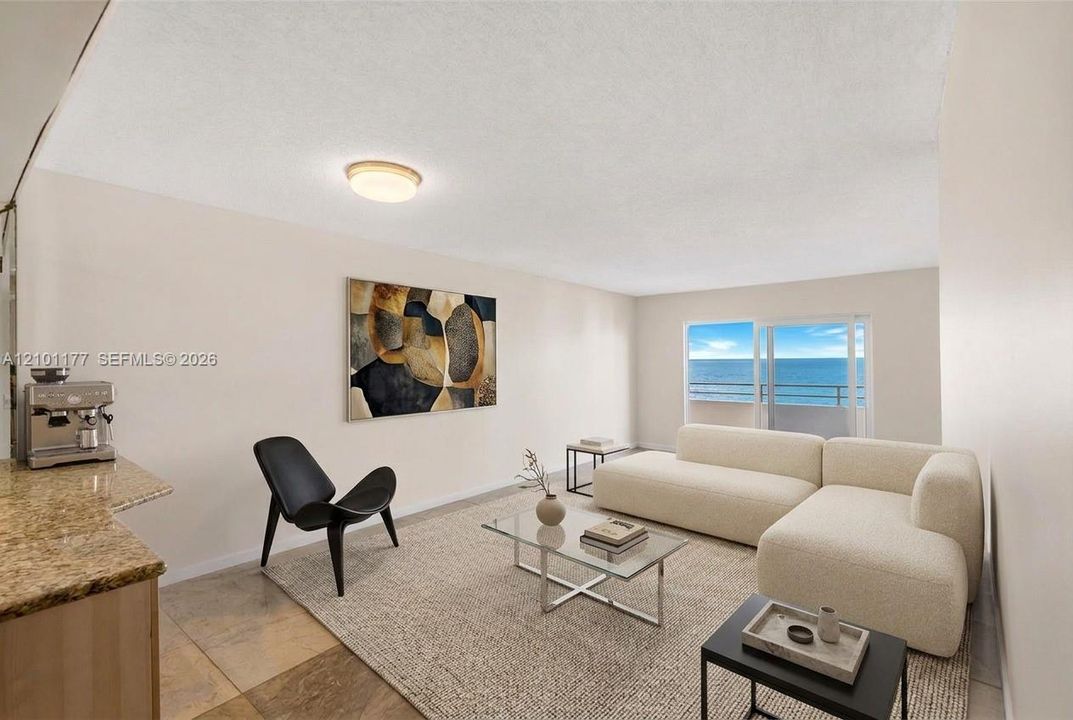 Living space featuring large sliding glass doors, neutral interior paint, stone-finish countertops, and flush-mount ceiling lighting