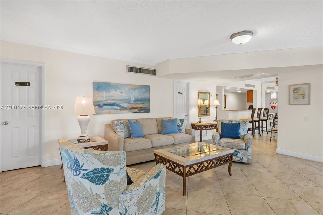 Neutral-tone tile flooring, flush-mount ceiling lighting, and arched architectural soffit
