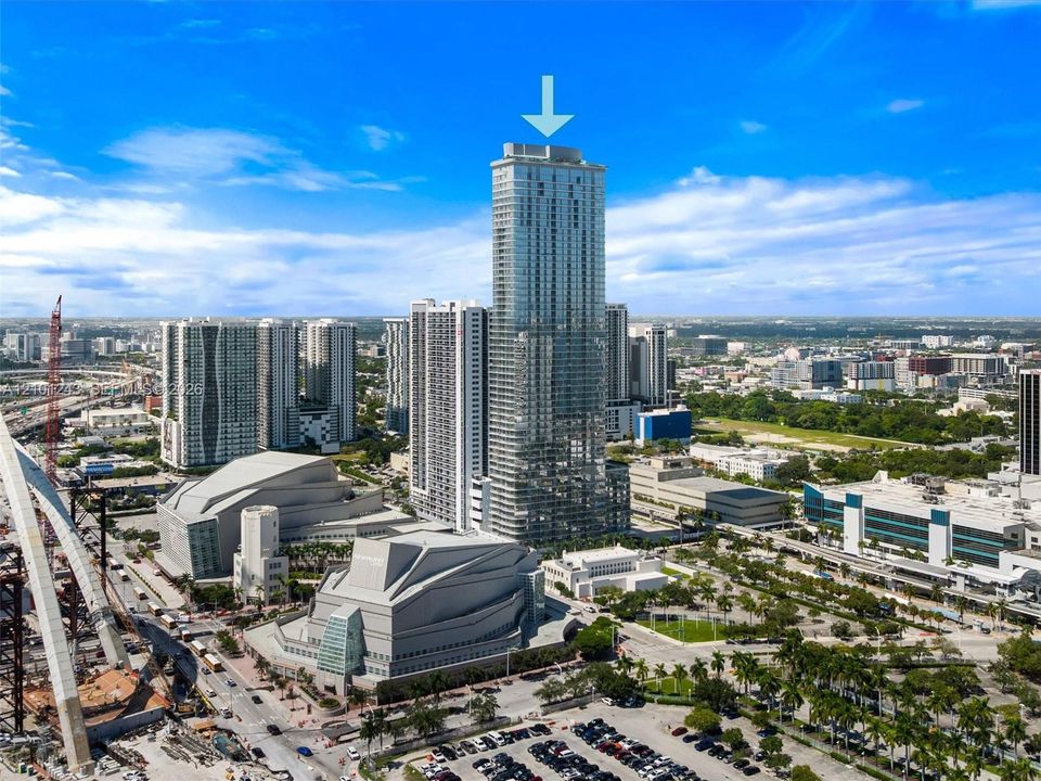 High-rise tower featuring a glass facade and a prominent central location within a metropolitan urban district