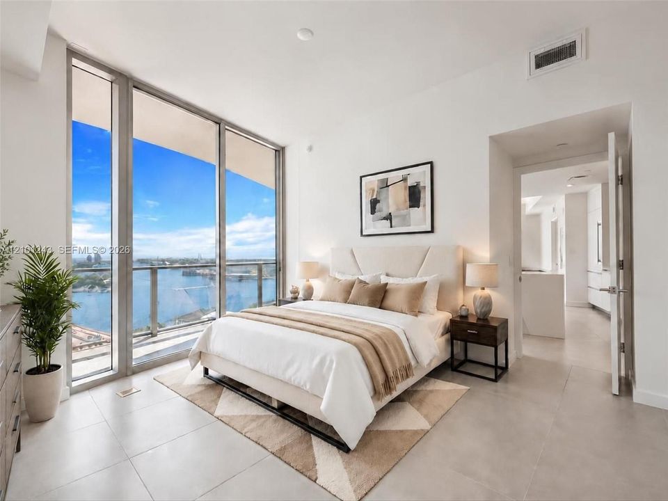 Floor-to-ceiling windows, porcelain tile flooring, and integrated balcony access featuring metal and glass railing