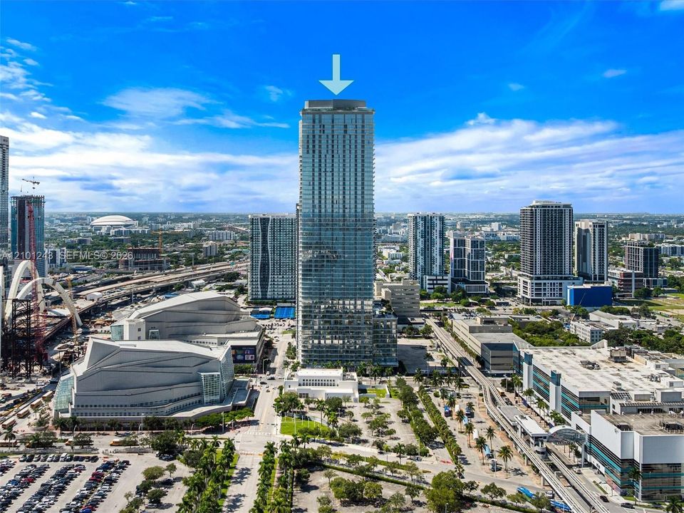High-rise tower featuring a glass facade, expansive floor-to-ceiling windows, and private balconies