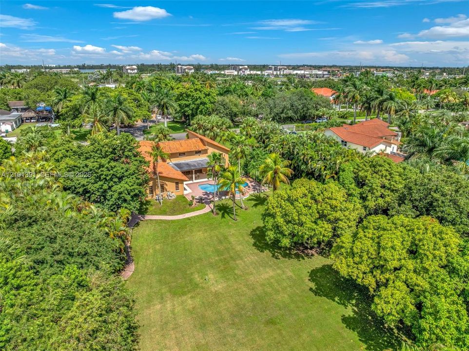 Expansive property featuring a large lawn, a private swimming pool, and a terracotta tile roof