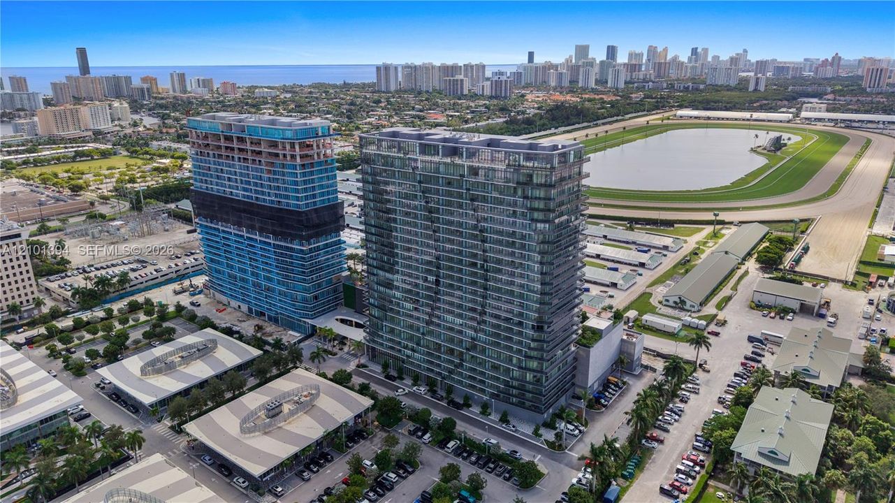High-rise glass and steel residential towers featuring private balconies, floor-to-ceiling windows, and expansive urban horizon exposure