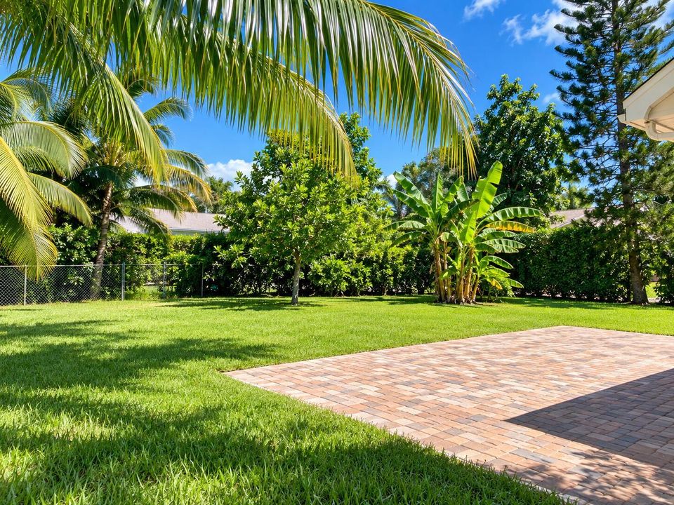Sunny Tropical Backyard with Paver Patio