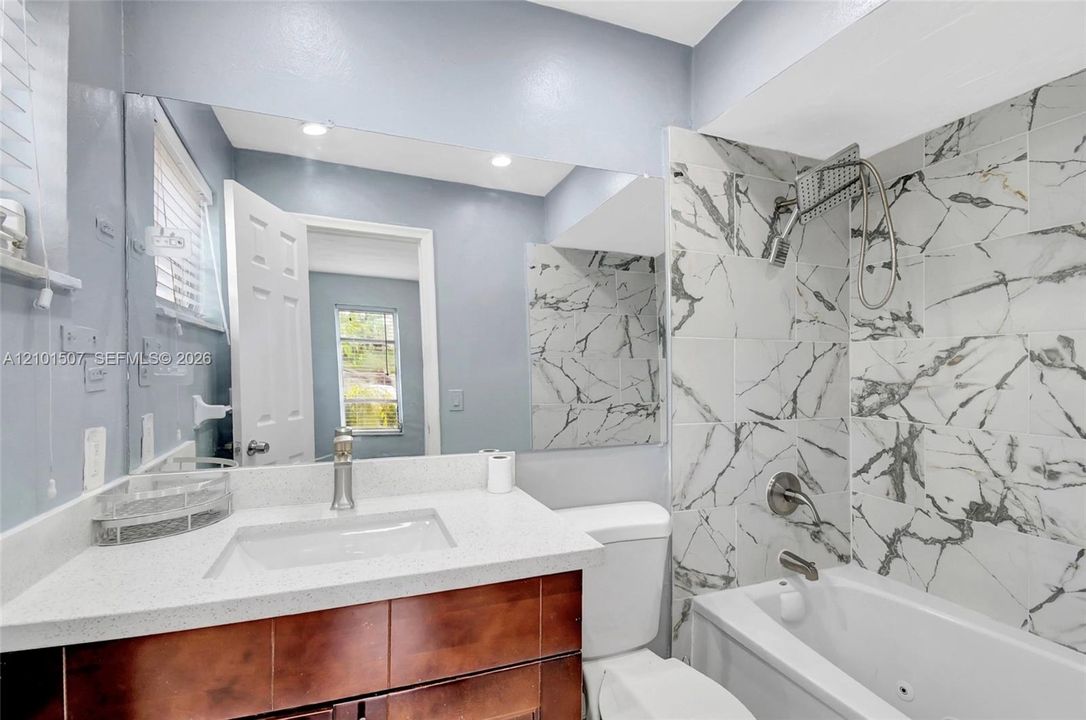 Bathroom 1 - bathtub and white patterned walls