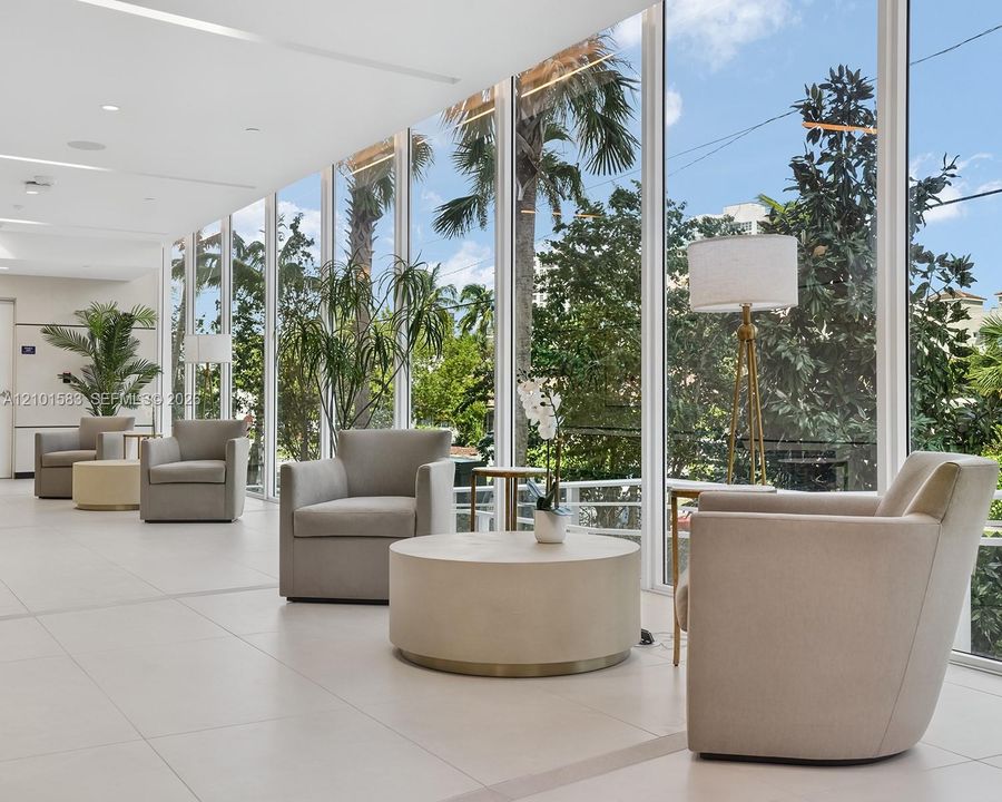 Floor-to-ceiling glass windows, recessed ceiling lighting, and large-format porcelain tile flooring