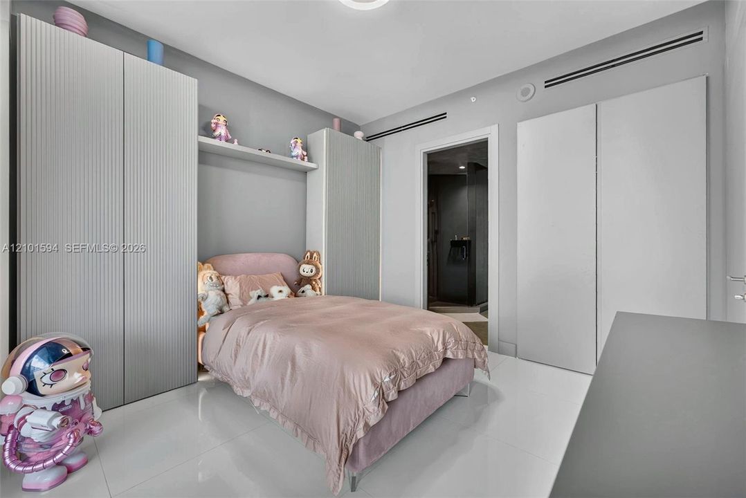 Secondary bedroom with built-in storage and a clean modern design.