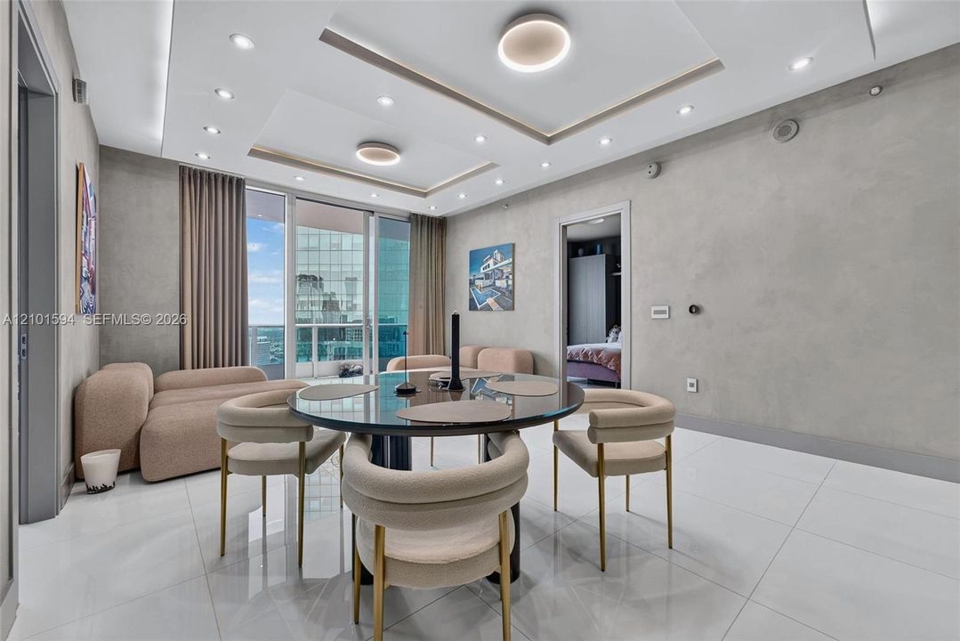 Dining area surrounded by natural light and open to the living space.