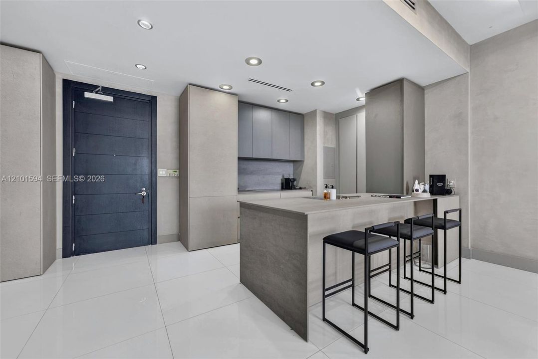 Kitchen island with seating and direct connection to the main living area.