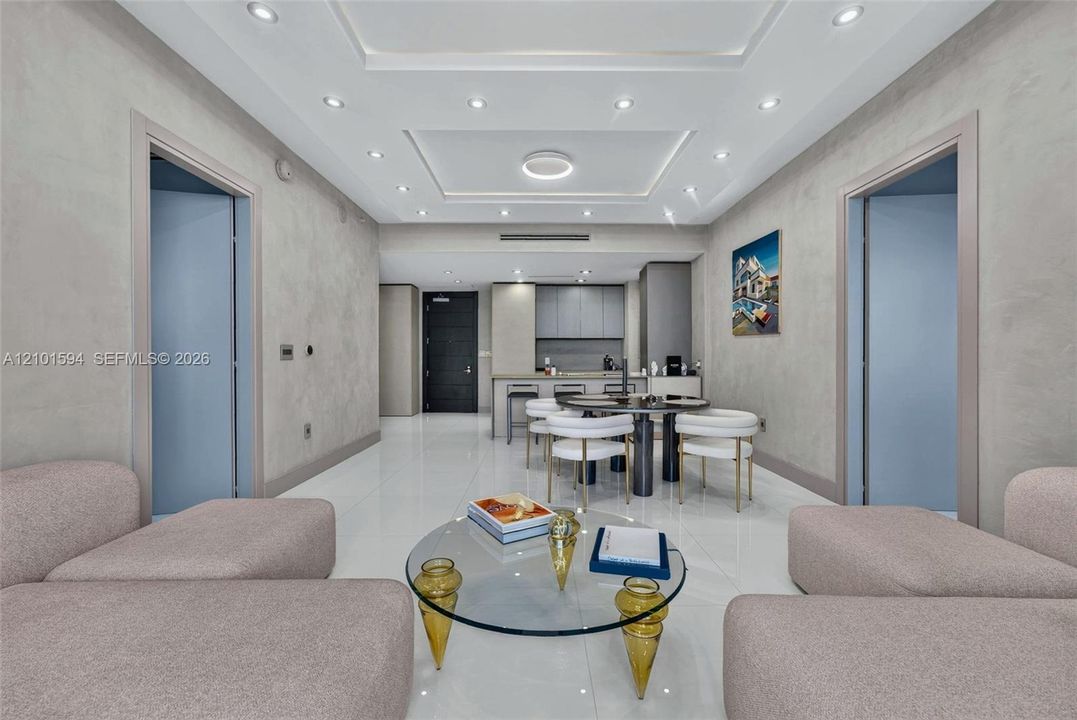 Living room open to the dining area and kitchen, with modern finishes.