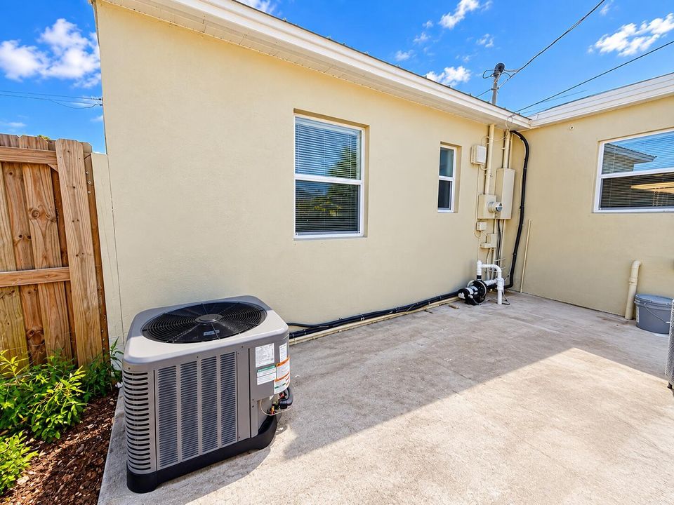 Sunny Backyard Home Exterior with HVAC U