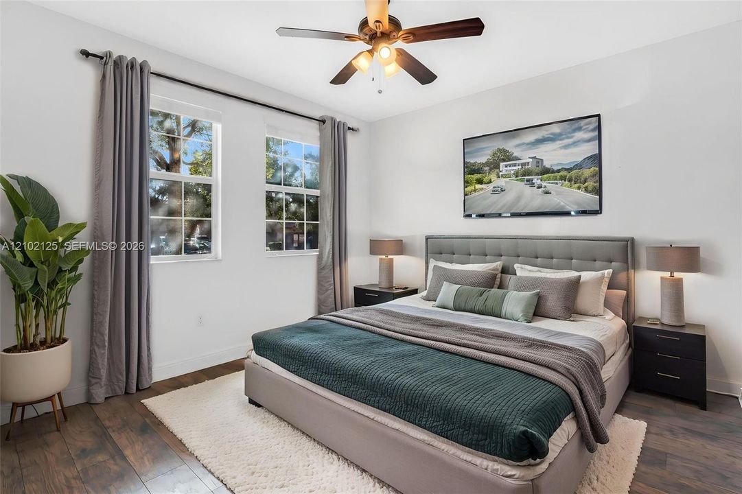 Virtually Stage - Room featuring wood-finish flooring, dual windows, and a ceiling fan with integrated lighting