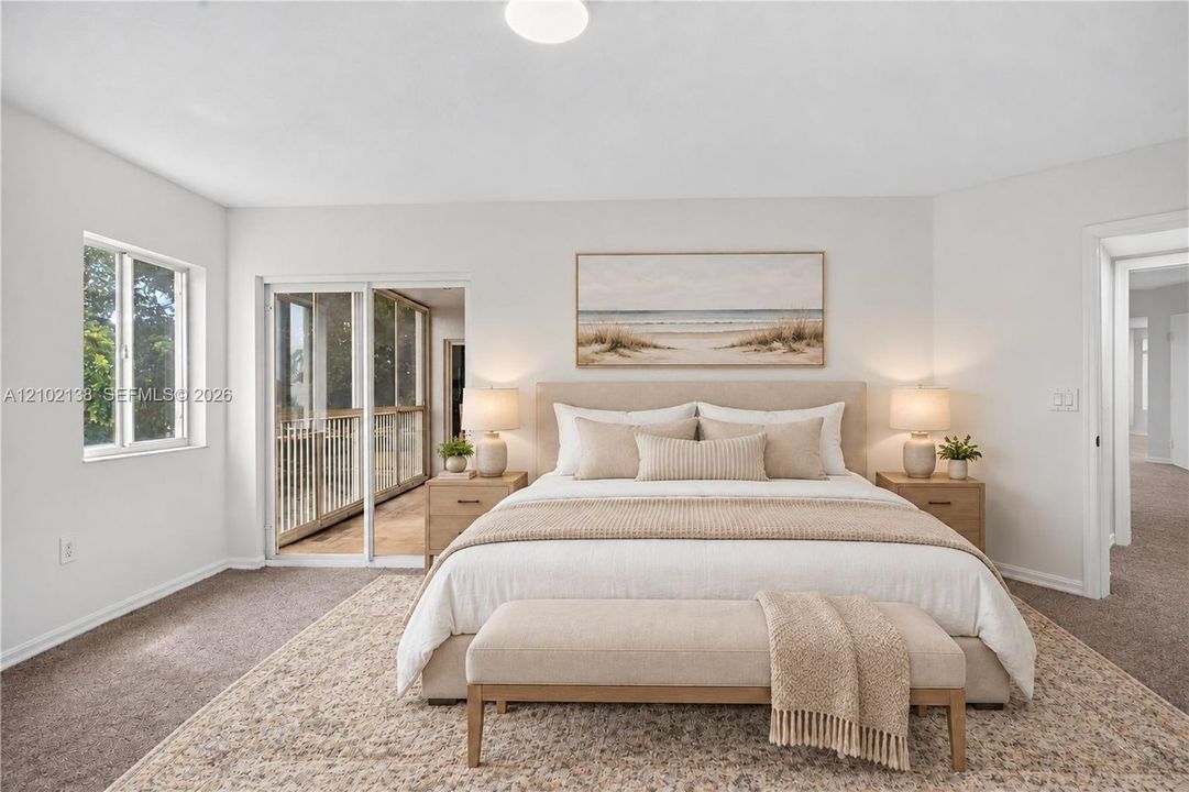Neutral-toned room with wall-to-wall carpeting, sliding glass doors, flush-mount ceiling lighting, and natural light via single-hung windows