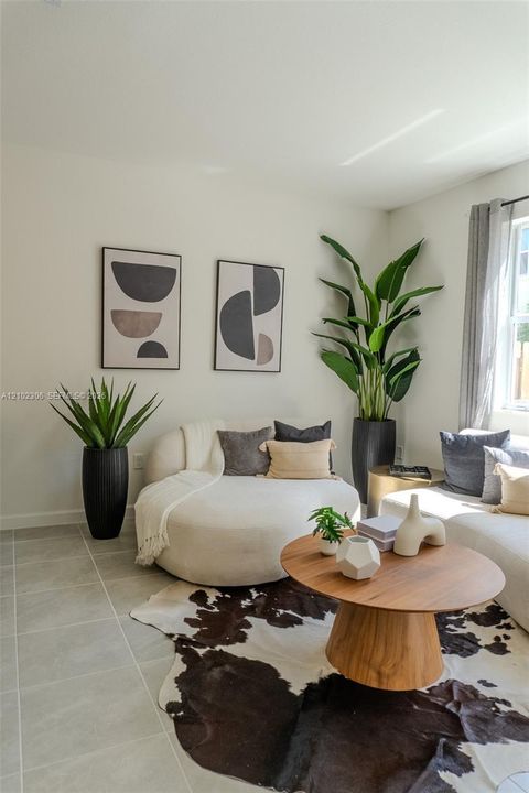 Neutral-toned ceramic tile flooring and natural light from a side window