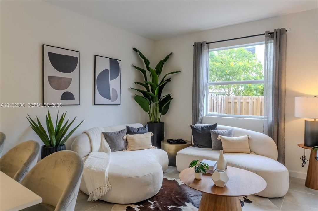 Neutral walls and large-format tile flooring complemented by a single-hung window