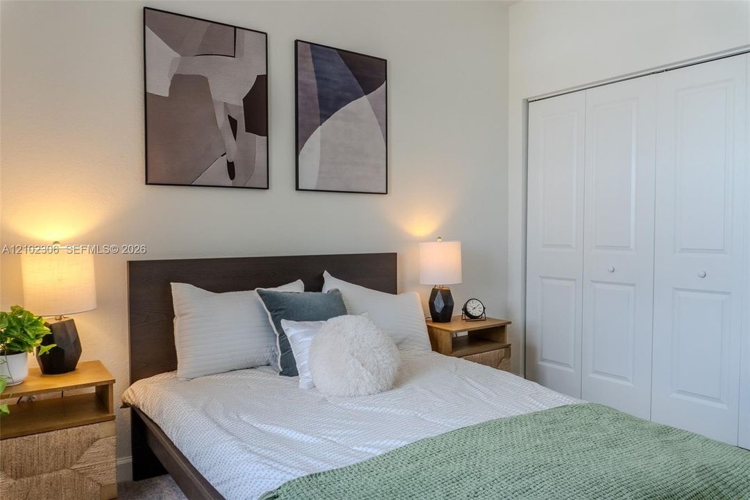 Room featuring neutral wall paint and a built-in closet with six-panel doors