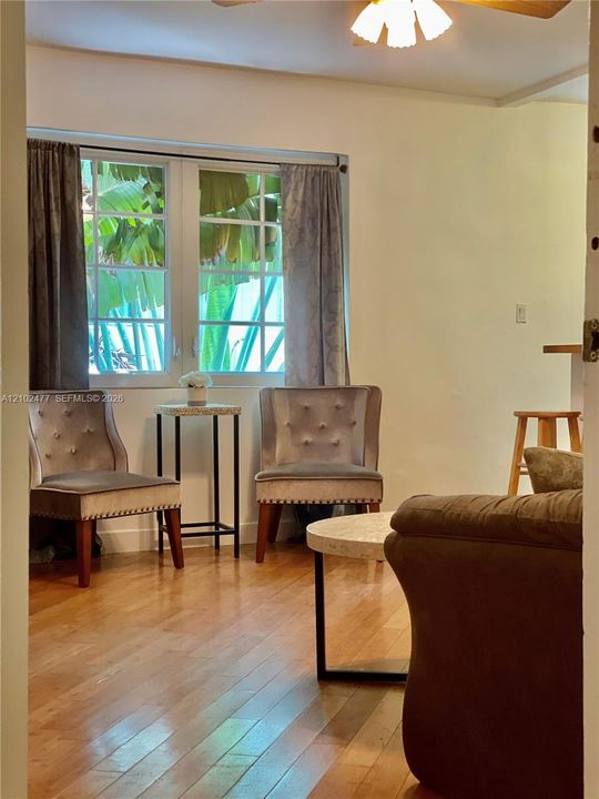 Wood-finish flooring, multi-pane casement window, and overhead ceiling fan fixture