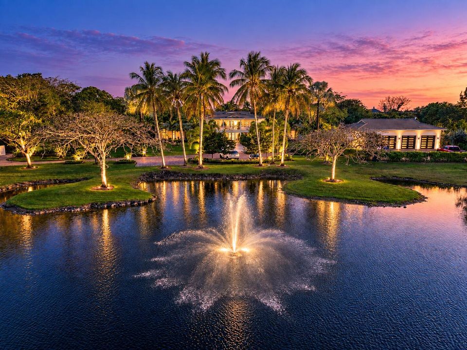 Twilight estate with glowing fountains