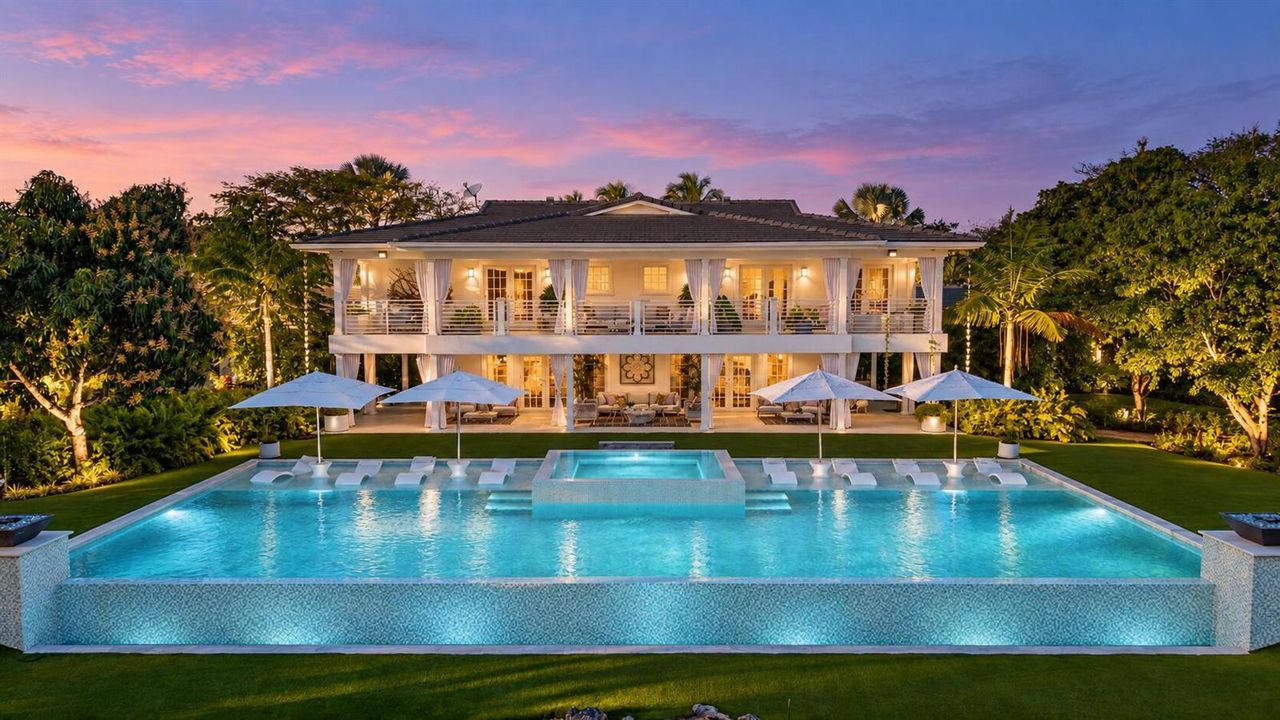 Twilight luxury home with glowing infini