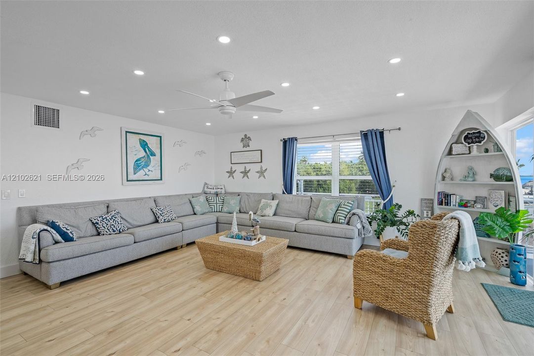 Wood-finish flooring, recessed lighting, and a ceiling fan