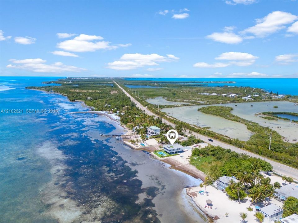 Waterfront property with direct water frontage, a private dock, and a dedicated pool area