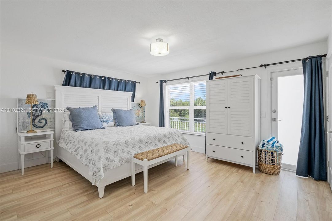 Recessed lighting, wood-finish flooring, and a glass-paned exterior door