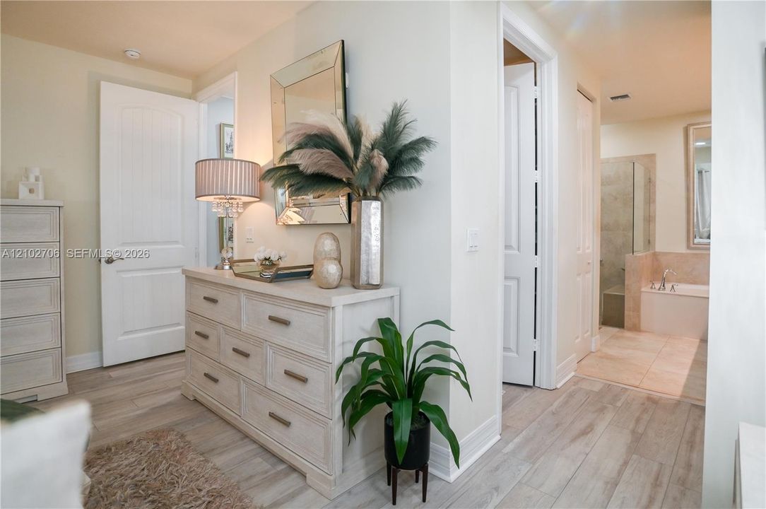 Interior corner featuring wood-finish flooring, custom chair rail molding, and neutral wall paint