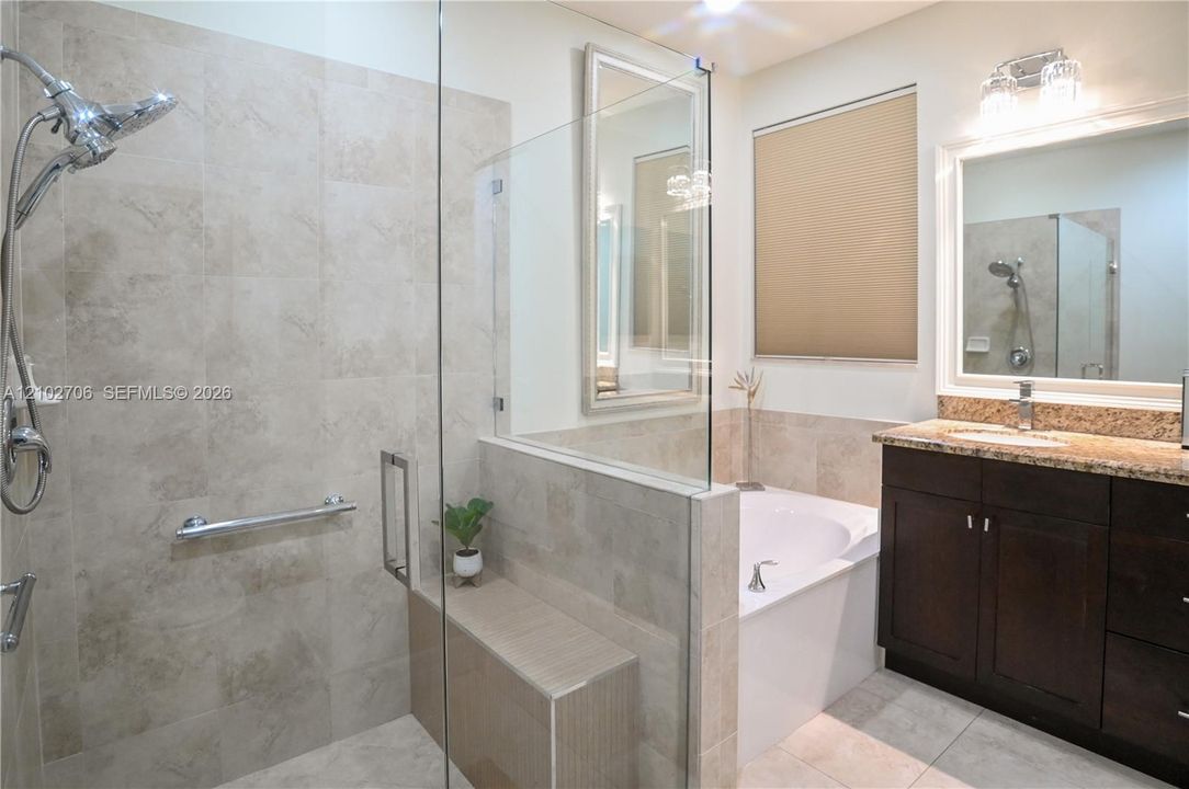 Neutral-toned wood-finish flooring, double-panel interior closet door, and window with installed horizontal blinds