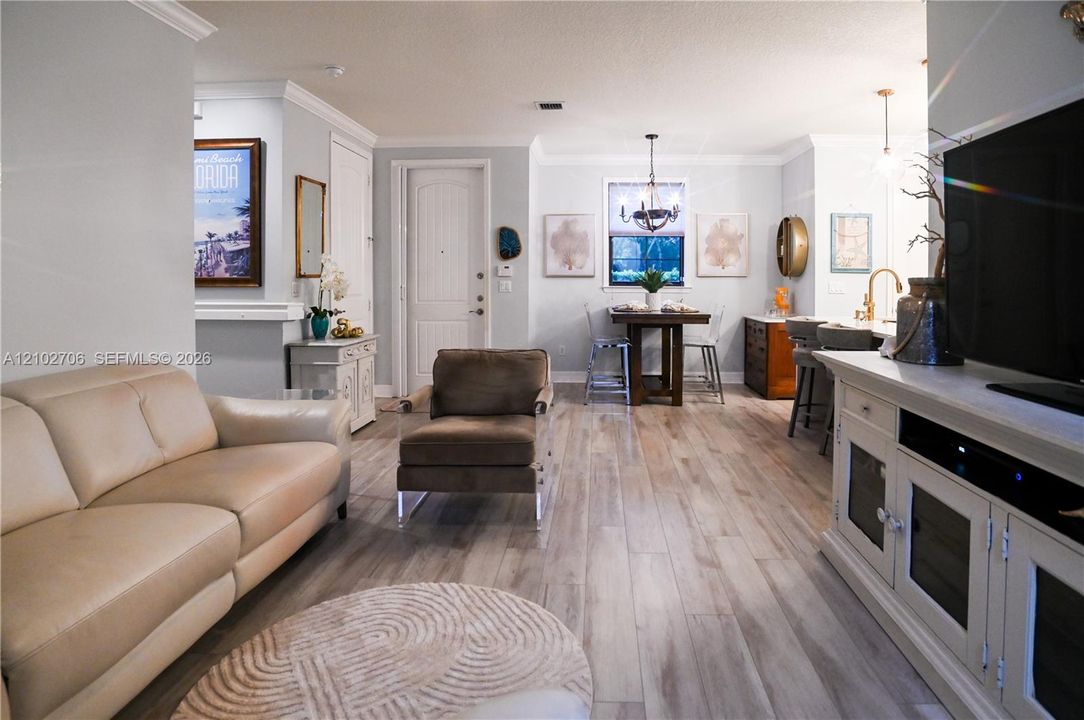 Kitchen featuring wood cabinetry, quartz countertops, dual glass pendant lights, stainless steel appliances and built-in microwave
