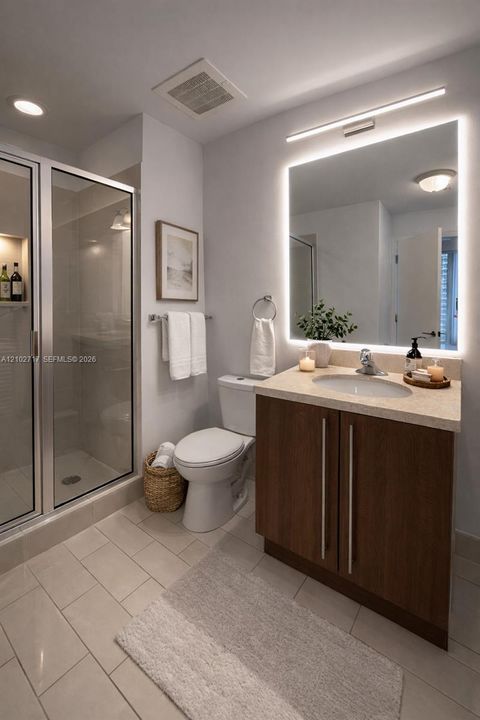 Bathroom featuring a vanity with wood-finish cabinetry, a neutral stone-surface countertop, an integrated sink, and an illuminated mirror