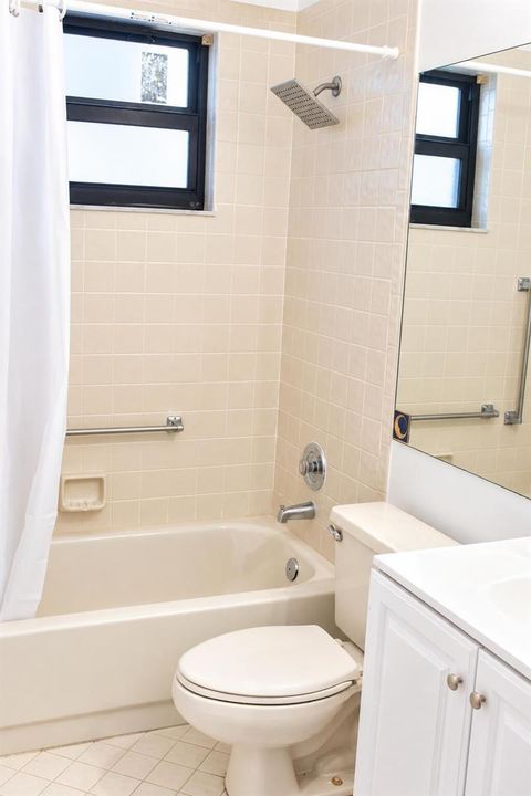 Bright Neutral Bathroom with Tub and Van