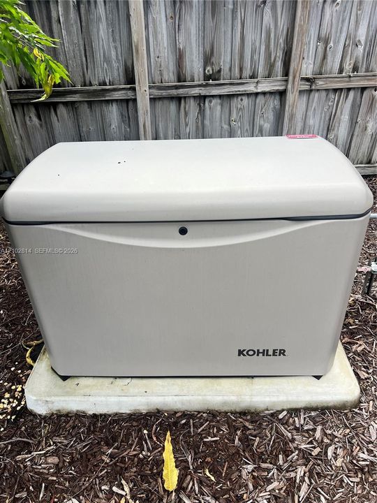 Kohler whole-home standby generator mounted on a reinforced concrete pad