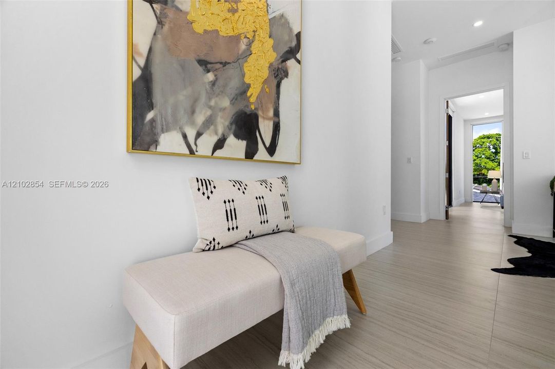 Light-toned wood-finish flooring and recessed ceiling lighting