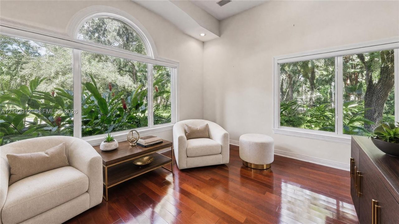 Hardwood flooring, vaulted ceiling, recessed lighting, expansive windows, arched transom window